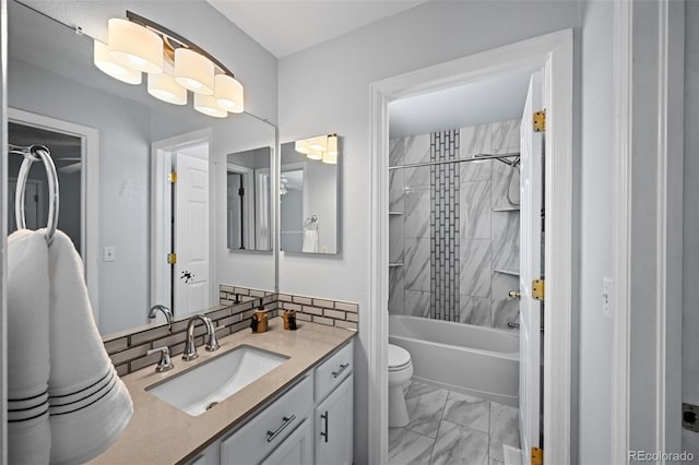 bathroom featuring marble finish flooring, toilet, bathing tub / shower combination, and vanity