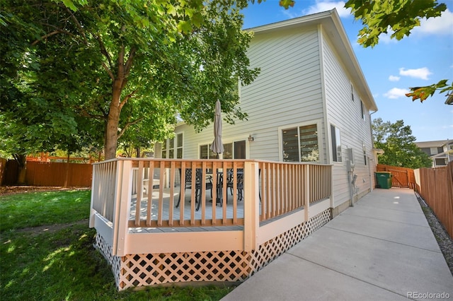 rear view of property featuring a wooden deck
