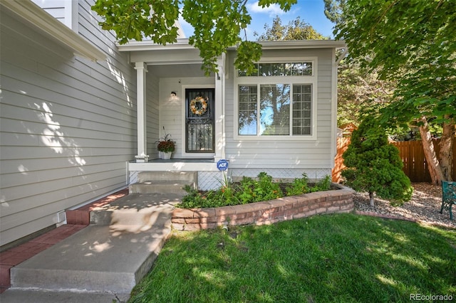 entrance to property featuring fence