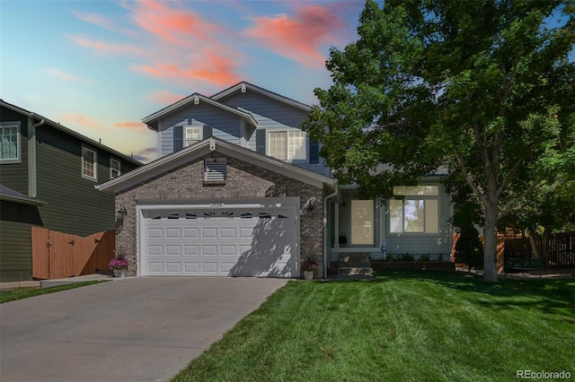 traditional-style house with concrete driveway, an attached garage, and brick siding