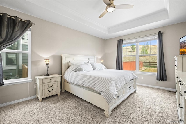 6174 Flattop St, Golden, CO 80403 - bedroom with a raised ceiling, light carpet, crown molding, baseboards, and a ceiling fan