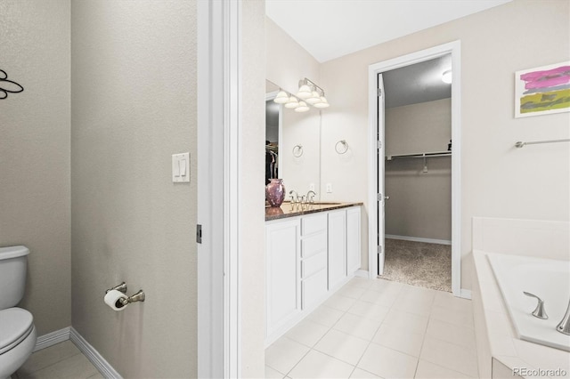6174 Flattop St, Golden, CO 80403 - full bathroom featuring toilet, a bath, a walk in closet, vanity, and baseboards