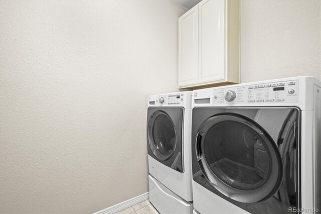 6174 Flattop St, Golden, CO 80403 - laundry area with washing machine and dryer, cabinet space, baseboards, and light tile patterned floors