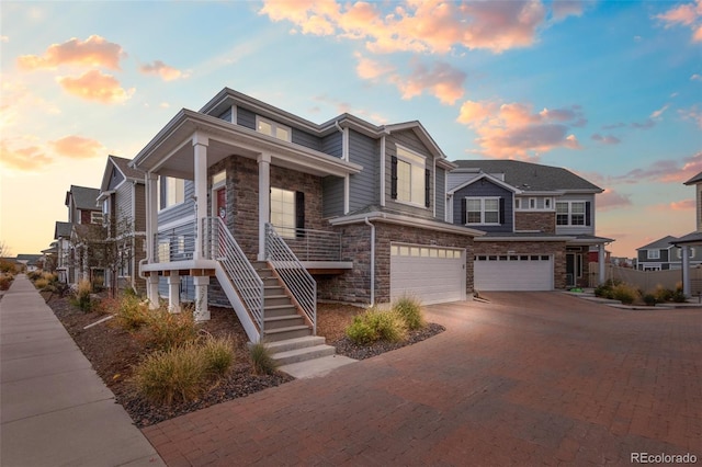 view of front of house featuring a porch and a garage