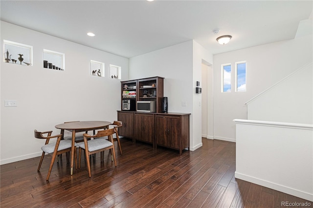 dining area with dark wood-type flooring