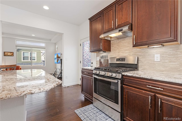 kitchen featuring light stone counters, dark hardwood / wood-style flooring, stainless steel gas range, and backsplash