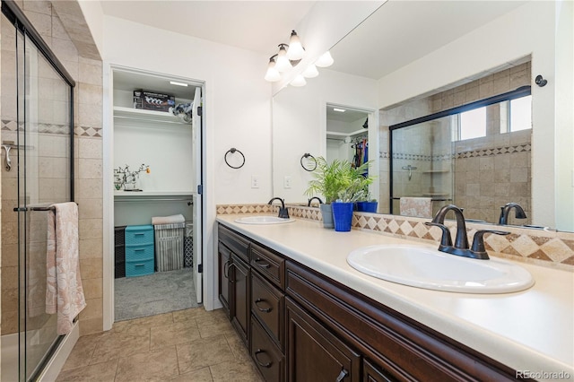 bathroom with vanity and a shower with shower door