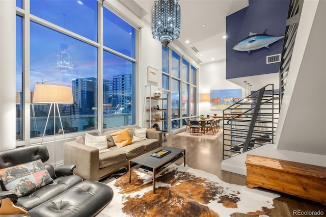 55 W 12th Ave Unit 608, Denver, CO 80204 - living room featuring wood finished floors, a chandelier, stairway, a view of city, and recessed lighting