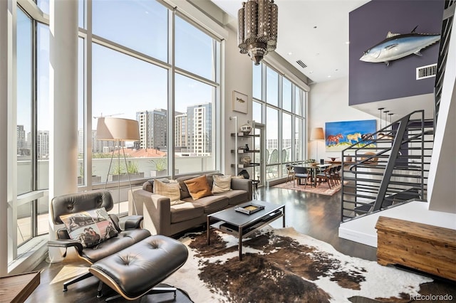 55 W 12th Ave Unit 608, Denver, CO 80204 - living area with wood finished floors, a high ceiling, stairs, a city view, and recessed lighting