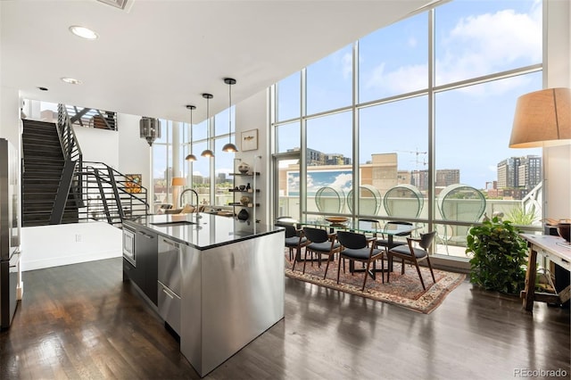 55 W 12th Ave Unit 608, Denver, CO 80204 - kitchen with freestanding refrigerator, dark wood finished floors, healthy amount of natural light, a view of city, and a wall of windows