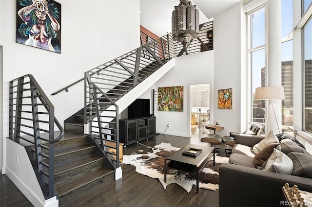 55 W 12th Ave Unit 608, Denver, CO 80204 - living room featuring a high ceiling, stairs, wood finished floors, and a chandelier