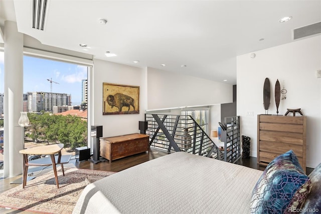 55 W 12th Ave Unit 608, Denver, CO 80204 - bedroom with multiple windows, recessed lighting, wood finished floors, and a view of city
