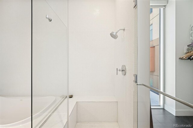 55 W 12th Ave Unit 608, Denver, CO 80204 - bathroom with a tile shower, a bath, and tile patterned floors