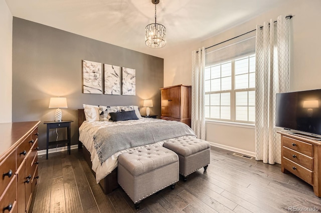 21855 E Idyllwilde Dr, Parker, CO 80138 - bedroom featuring dark wood-style flooring and a chandelier