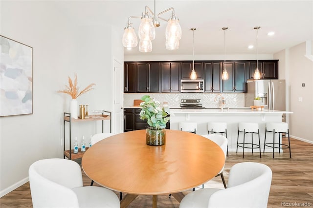 6041 N Orleans St, Aurora, CO 80019 - dining room with light wood-style floors, baseboards, and recessed lighting