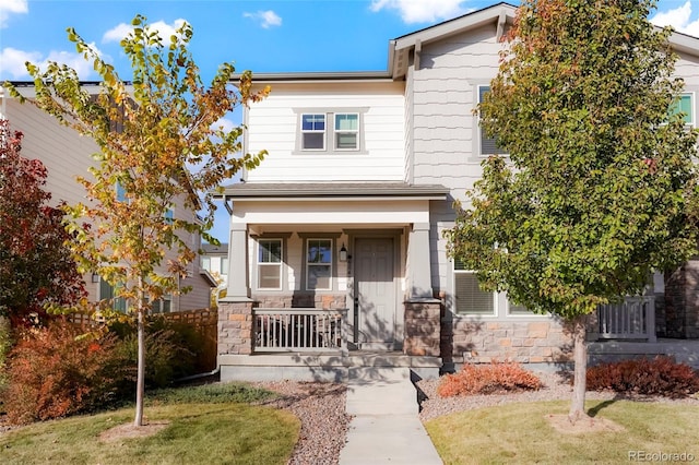 6041 N Orleans St, Aurora, CO 80019 - view of front facade with a porch, stone siding, and a front lawn