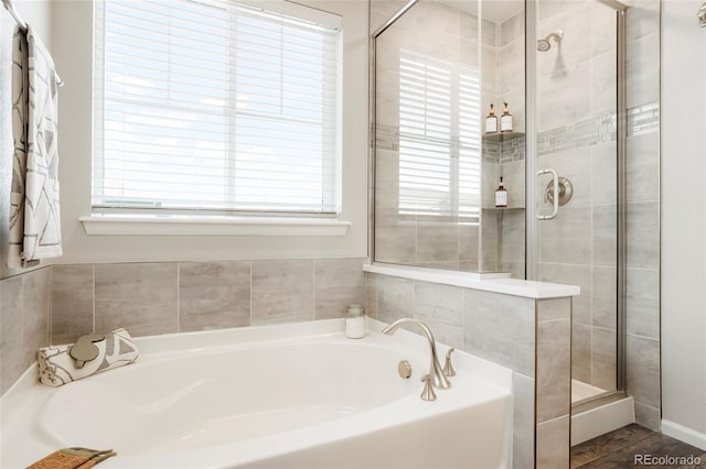 6041 N Orleans St, Aurora, CO 80019 - full bathroom featuring a bath, a shower stall, and plenty of natural light
