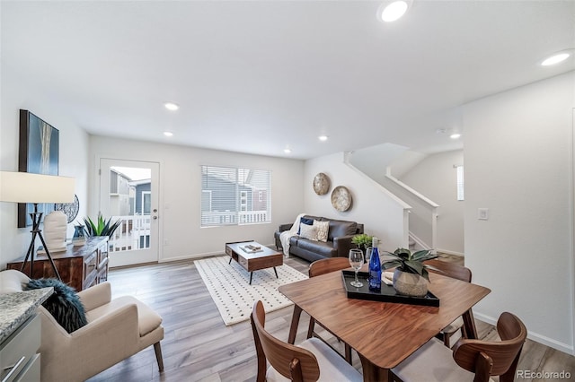 dining space featuring stairs, recessed lighting, light wood-style floors, and baseboards