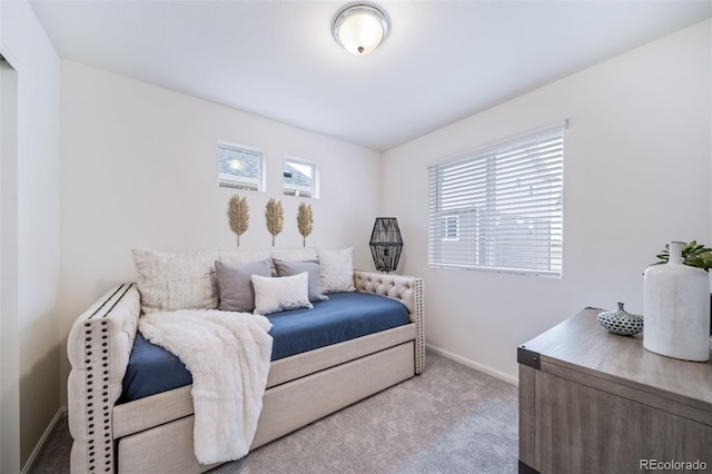 bedroom with baseboards and carpet