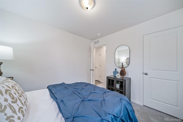 bedroom featuring visible vents and light carpet