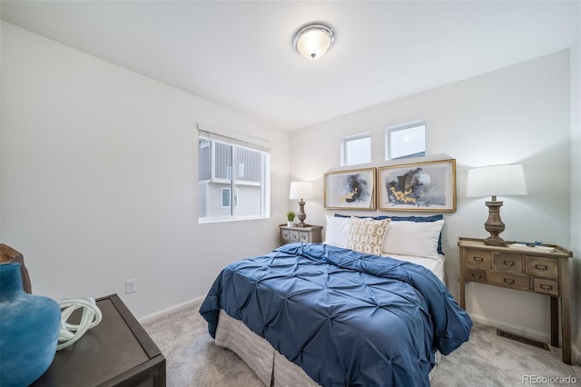 bedroom with carpet flooring, baseboards, and visible vents