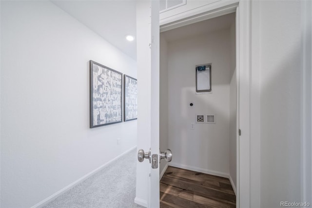 laundry area featuring electric dryer hookup, visible vents, wood finished floors, baseboards, and laundry area