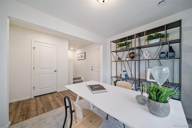 office area with baseboards and wood finished floors