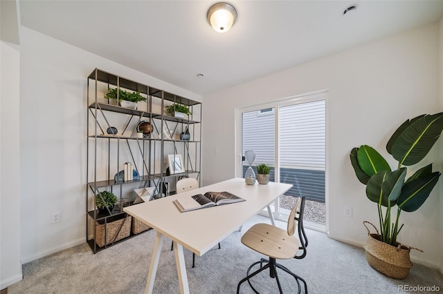 office space with light carpet and baseboards