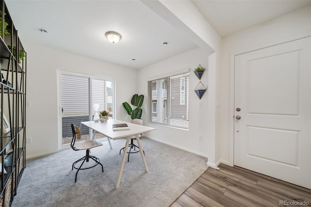 home office featuring wood finished floors and baseboards