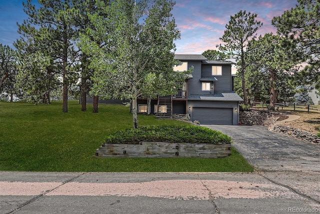 view of front of property with a lawn and a garage