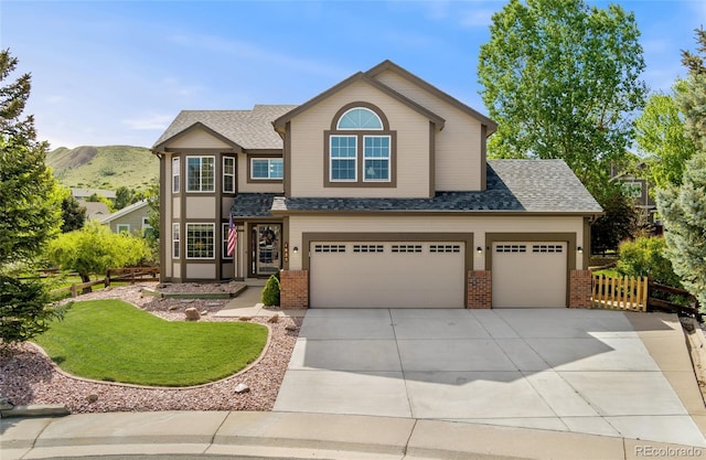 1825 Cooper Ct, Castle Rock, CO 80109 - view of front of property featuring brick siding, driveway, a shingled roof, and a mountain view