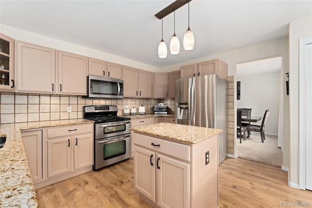 1825 Cooper Ct, Castle Rock, CO 80109 - kitchen with appliances with stainless steel finishes, light wood-type flooring, decorative backsplash, light stone counters, and glass insert cabinets