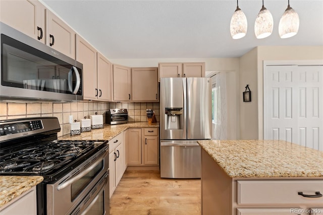 1825 Cooper Ct, Castle Rock, CO 80109 - kitchen featuring stainless steel appliances, light wood-style floors, decorative backsplash, and light stone counters