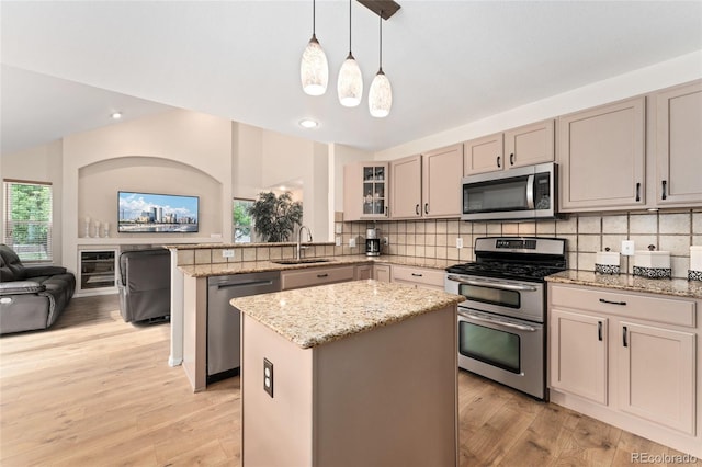 1825 Cooper Ct, Castle Rock, CO 80109 - kitchen with stainless steel appliances, a sink, a peninsula, a kitchen island, and open floor plan