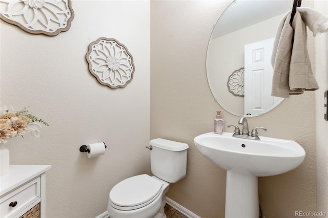 1825 Cooper Ct, Castle Rock, CO 80109 - bathroom with toilet, a sink, and baseboards
