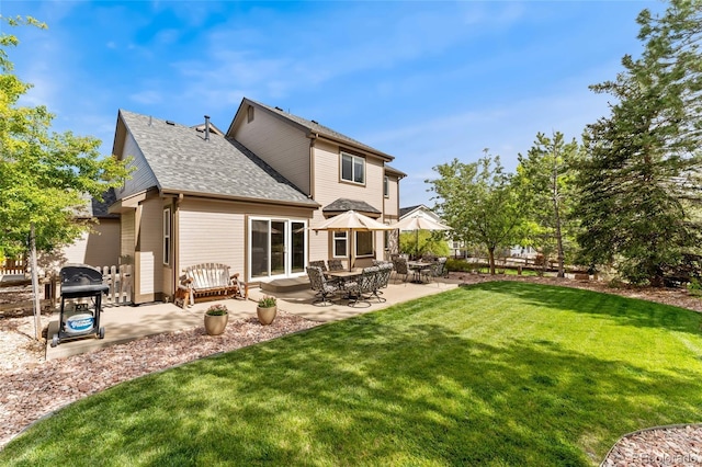 1825 Cooper Ct, Castle Rock, CO 80109 - back of property with a yard, a patio, and roof with shingles