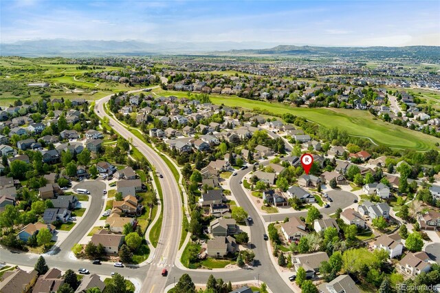 1825 Cooper Ct, Castle Rock, CO 80109 - aerial overview of property's location with a mountain backdrop, nearby suburban area, and a local golf course