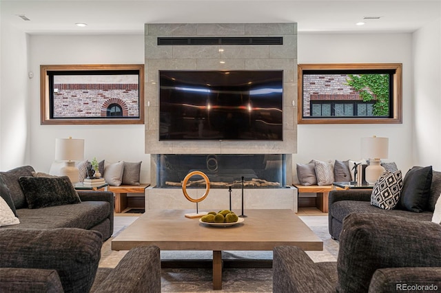 living room featuring a tile fireplace