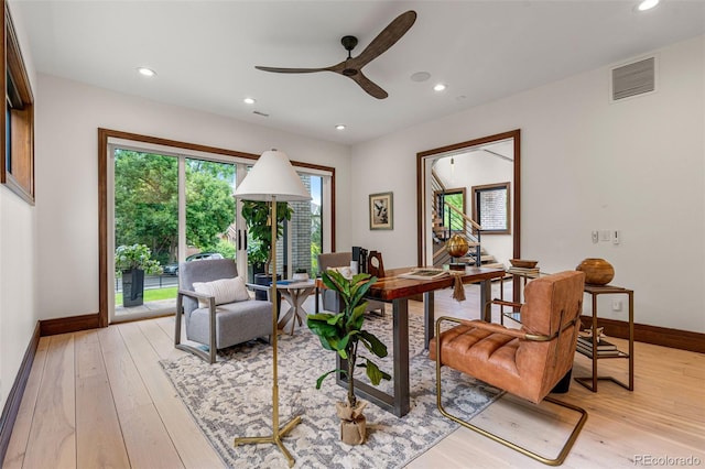 sitting room with light wood-type flooring and ceiling fan