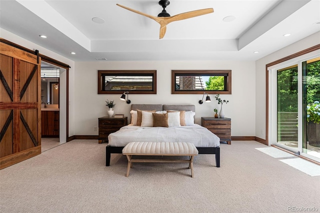 bedroom with light carpet, access to exterior, a barn door, and ceiling fan