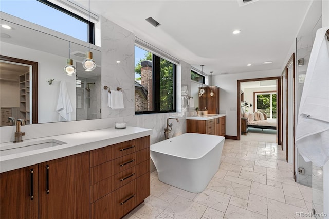 bathroom featuring separate shower and tub, tile walls, and vanity