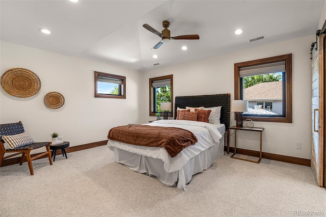 bedroom with ceiling fan and light colored carpet