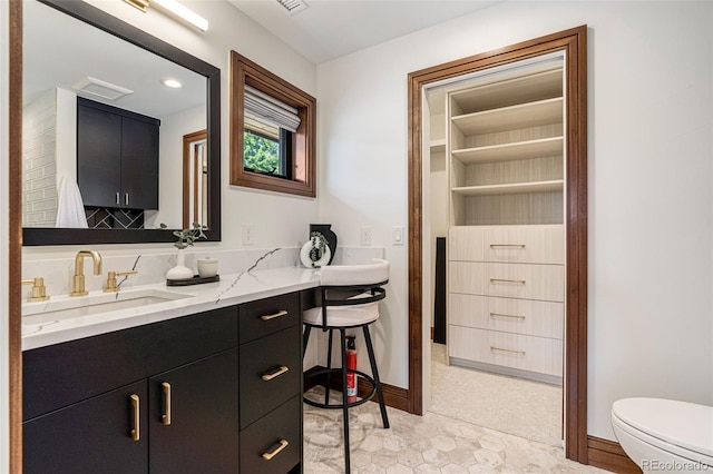 bathroom featuring vanity and toilet