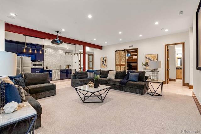 living room with sink, brick wall, and light carpet