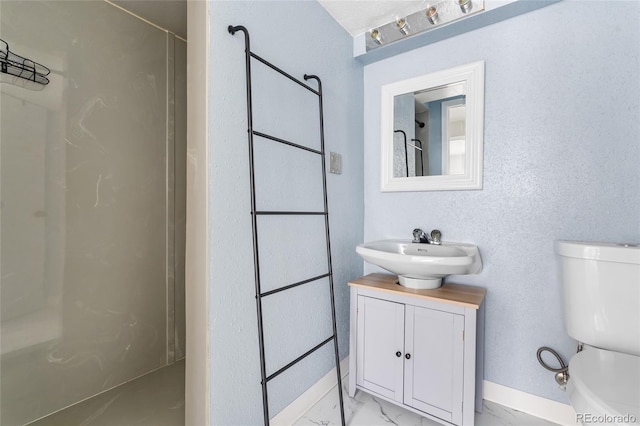 1740 S Ammons St Unit C, Lakewood, CO 80232 - bathroom featuring toilet, marble finish flooring, a shower, baseboards, and vanity