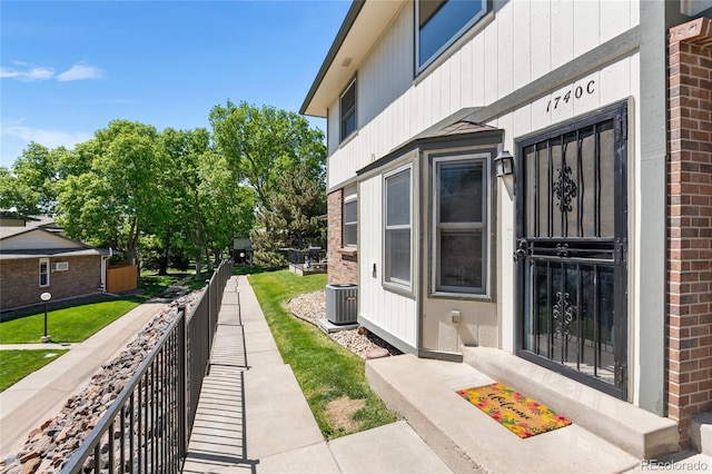 1740 S Ammons St Unit C, Lakewood, CO 80232 - doorway to property with brick siding and central AC
