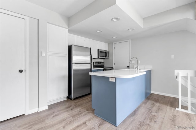 1740 S Ammons St Unit C, Lakewood, CO 80232 - kitchen with stainless steel appliances, a sink, a peninsula, light wood-type flooring, and recessed lighting