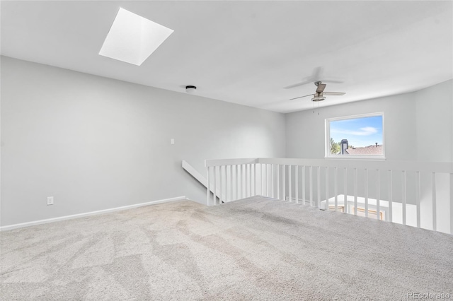 1740 S Ammons St Unit C, Lakewood, CO 80232 - carpeted spare room with a skylight, a ceiling fan, and baseboards