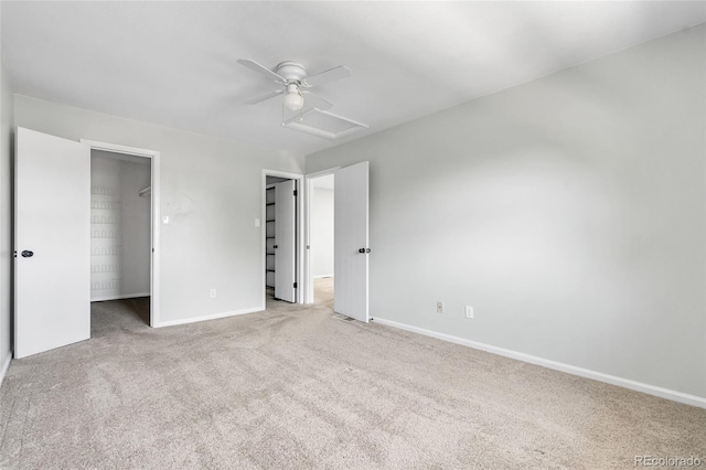 1740 S Ammons St Unit C, Lakewood, CO 80232 - unfurnished bedroom featuring a spacious closet, carpet, baseboards, attic access, and ceiling fan