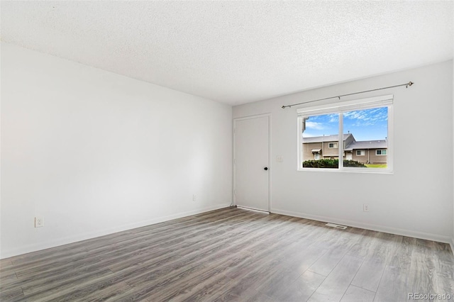 5711 W 92nd Ave Unit 47, Westminster, CO 80031 - unfurnished room featuring wood finished floors, a textured ceiling, and baseboards